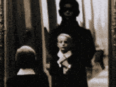 a black and white photo of a man and two boys
