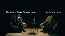 a man in a blue hoodie sitting next to another man in a brown chair