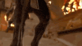 a close up of a horse 's legs in front of a fire .