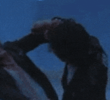 a blurry picture of two people standing next to each other in a dark room