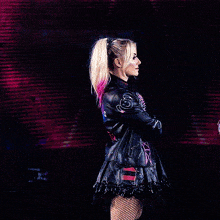 a woman in a black leather jacket with the letter s on the back