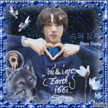 a picture of a man making a heart shape with his hands and the words earth written on the sweater