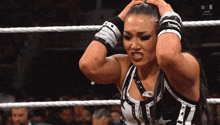a woman in a wrestling ring with the letters w on the bottom right