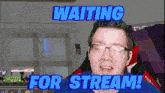 a man wearing glasses is waiting for a stream .