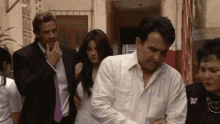 a man in a white shirt has a badge on his chest that says ' ec ' on it