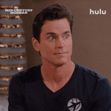 a man is wearing a black shirt that says mid century modern