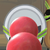 two red balls are stacked on top of each other in a bowling alley