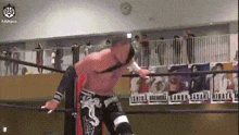 a man is wrestling in a ring with a sign that says sasaki on it