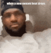 a man with a beard is wearing a black hat and a white shirt with the caption when a new kwaani beat drops
