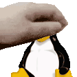 a close up of a hand holding a penguin