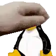 a close up of a hand holding a penguin