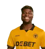a man wearing a yellow shirt that says debet