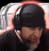 a man wearing headphones and a hat with a microphone