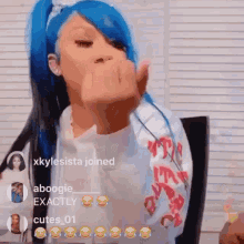 a girl with blue hair is giving the middle finger in a video