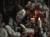 a woman sitting at a table writing with a quill