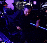 a man is dancing in a dark room with a sign that says ecity