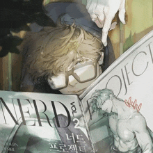 a man wearing glasses is reading a magazine called nerd vol 2