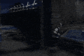 a man is getting out of a car in front of a sign that says ' motel ' on it