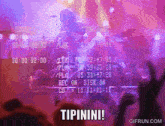 a crowd of people watching a concert with the words tipinini on the bottom