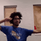 a man wearing headphones and a blue shirt that says run hob salutes