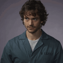 a man in a prison uniform with the number b 1327-1