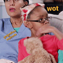 a woman wearing scrubs that say euphoria is sitting next to a young girl holding a teddy bear