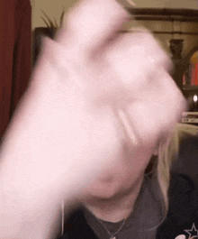 a close up of a person 's hand making a fist