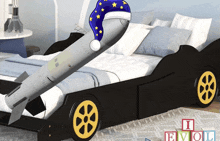 a bed that has a rocket on it and the letters eviol on the floor