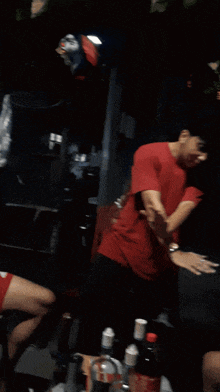 a blurry photo of a man in a red shirt
