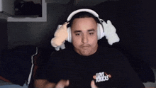 a man wearing headphones and a shirt that says love toxics