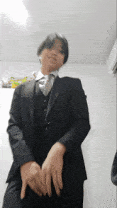a young man in a suit and tie is dancing