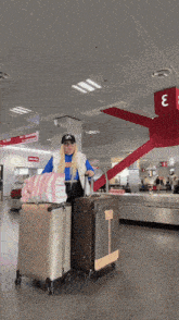 a woman wearing a new york yankees hat is pulling a suitcase