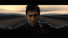 a pixelated image of a man standing on a road with his arms outstretched