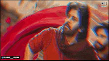 a man in a red shirt is standing in front of a red car with the words pranay_varma below him