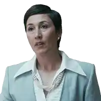 a woman wearing a pearl necklace and a blue suit