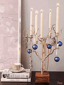 a candelabra with candles and blue ornaments is on a table