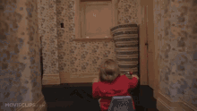 a man in a suit walks down a hallway with movieclips.com on the bottom