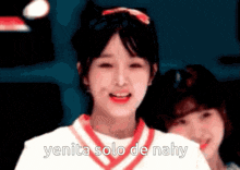 a girl in a white shirt with a red collar is smiling with the words yenita solo de nahy below her