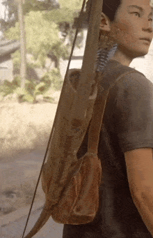 a man carrying a bow and arrow in a brown leather bag