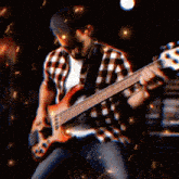 a man in a plaid shirt plays a bass guitar