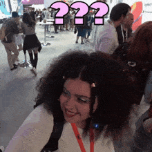 a woman with curly hair has a question mark on her head