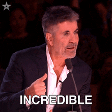a man in a suit is giving a thumbs up and the word incredible is behind him