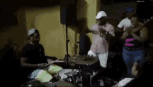 a man is playing drums in front of a group of people .