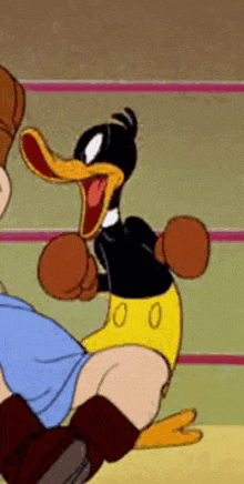 a cartoon duck is wearing boxing gloves and kicking a person .