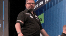 a man standing in front of a sign that says ' best of 5 sets '