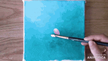 a person is painting a flower with a brush and the words made in animatica are on the bottom