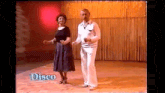 a man and a woman are dancing on a dance floor with the word disco on the bottom