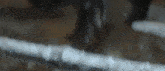 a blurred image of a person holding a sword in a dark room