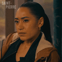 a woman in a brown jacket with saint-pierre written above her