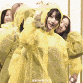 a girl wearing a yellow raincoat with qqlovepuppy on the bottom